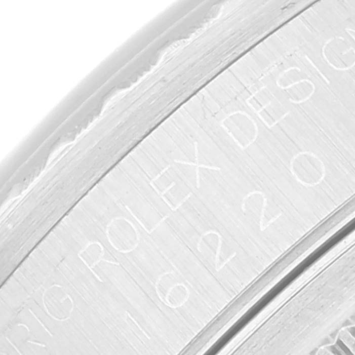 This close-up image shows the engraved text on the case of a Rolex Datejust 16220 Men's Stainless Steel Blue Dial 16220 Men's Stainless Steel Blue Dial watch.