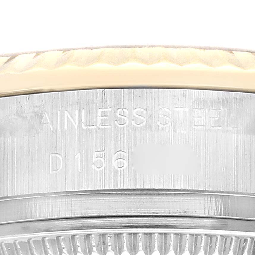 The image shows a close-up of the side of a Rolex Datejust 179173 Women's Steel and Gold (two tone) Champagne Dial 179173 Women's Steel and Gold (two tone) Champagne Dial watch, highlighting the stainless steel and part of the serial number.