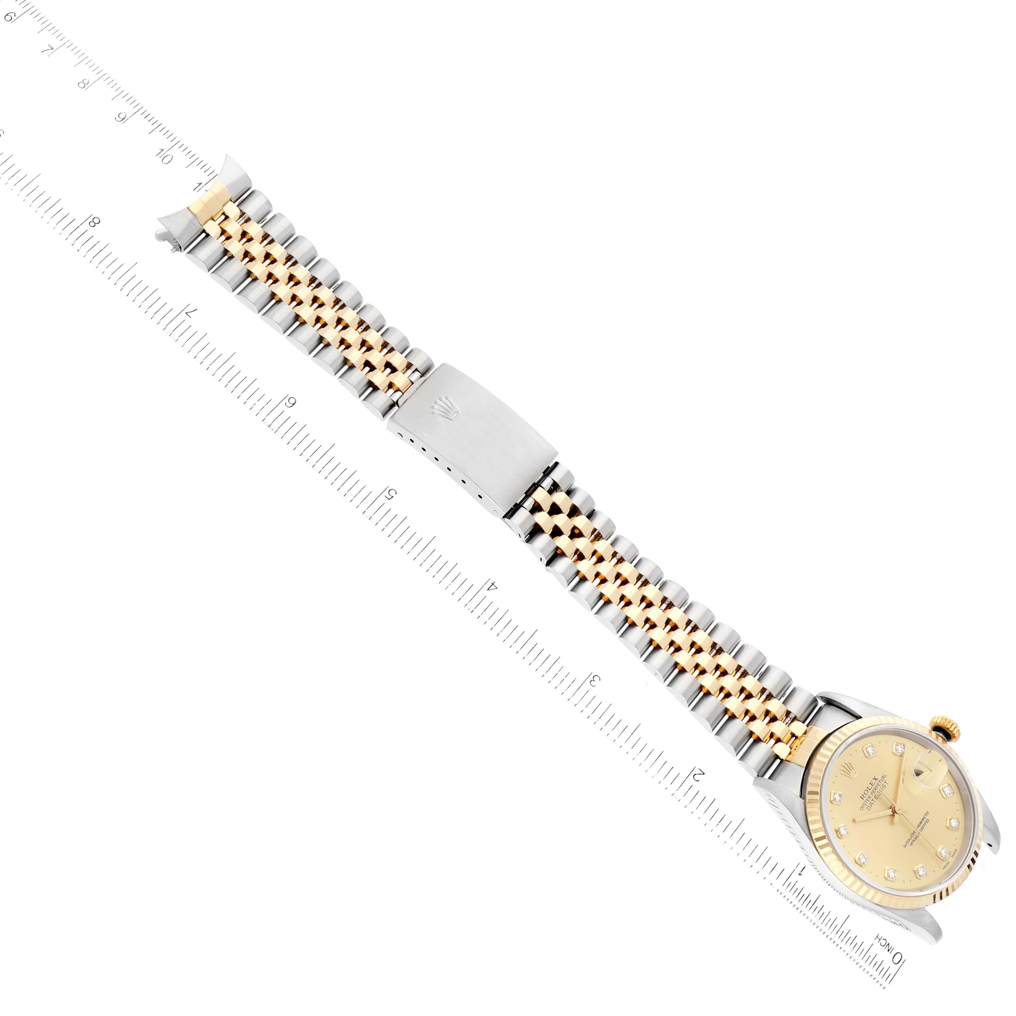 The image shows a Rolex Datejust 16233 Men's Steel and Gold (two tone) Champagne Dial 16233 Men's Steel and Gold (two tone) Champagne Dial watch laid flat with its bracelet and clasp fully visible against a ruler backdrop.