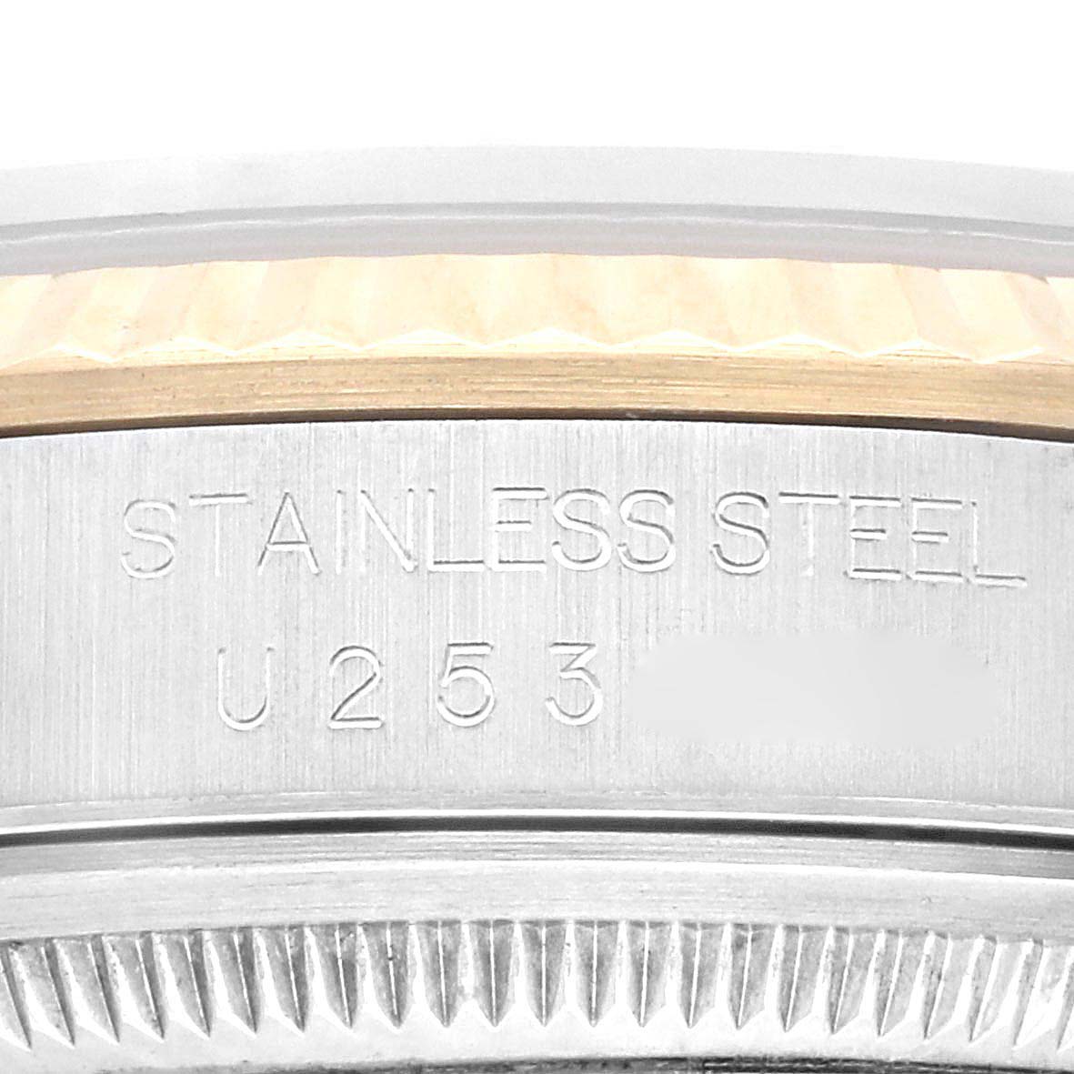 The image shows a close-up of the case side of a Rolex Datejust 16233 Men's Steel and Gold (two tone) Champagne Dial 16233 Men's Steel and Gold (two tone) Champagne Dial watch, highlighting the stainless steel engraving and reference numbers.