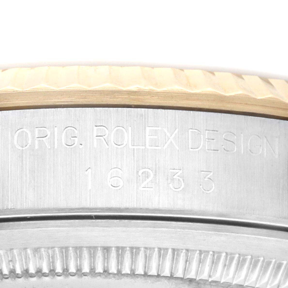 This close-up image of the Rolex Datejust 16233 Men's Steel and Gold (two tone) Champagne Dial 16233 Men's Steel and Gold (two tone) Champagne Dial watch shows the engraved text "ORIG. ROLEX DESIGN" and the model number "16233" on the case.