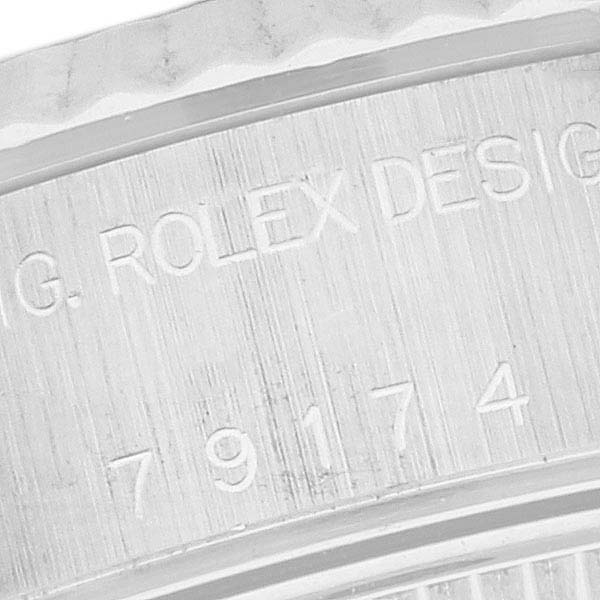 This close-up image shows the engraved serial number and branding on the case of a Rolex Datejust 79174 Women's Stainless Steel White Dial 79174 Women's Stainless Steel White Dial watch.