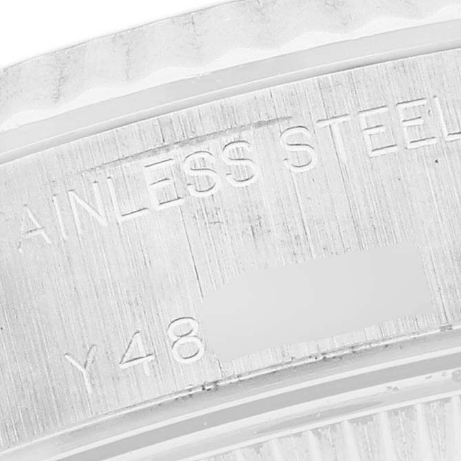 The image shows a close-up of the bezel and serial number engraving of a Rolex Datejust 79174 Women's Stainless Steel White Dial 79174 Women's Stainless Steel White Dial watch.