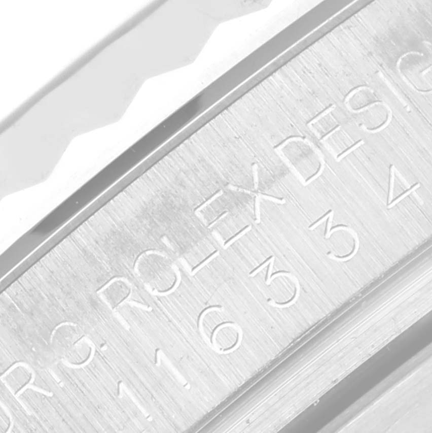 This close-up image shows the engraved side of the bezel and case of the Rolex Datejust 41 116334 Men
s Stainless Steel Blue Dial 116334 Men
s Stainless Steel Blue Dial watch.