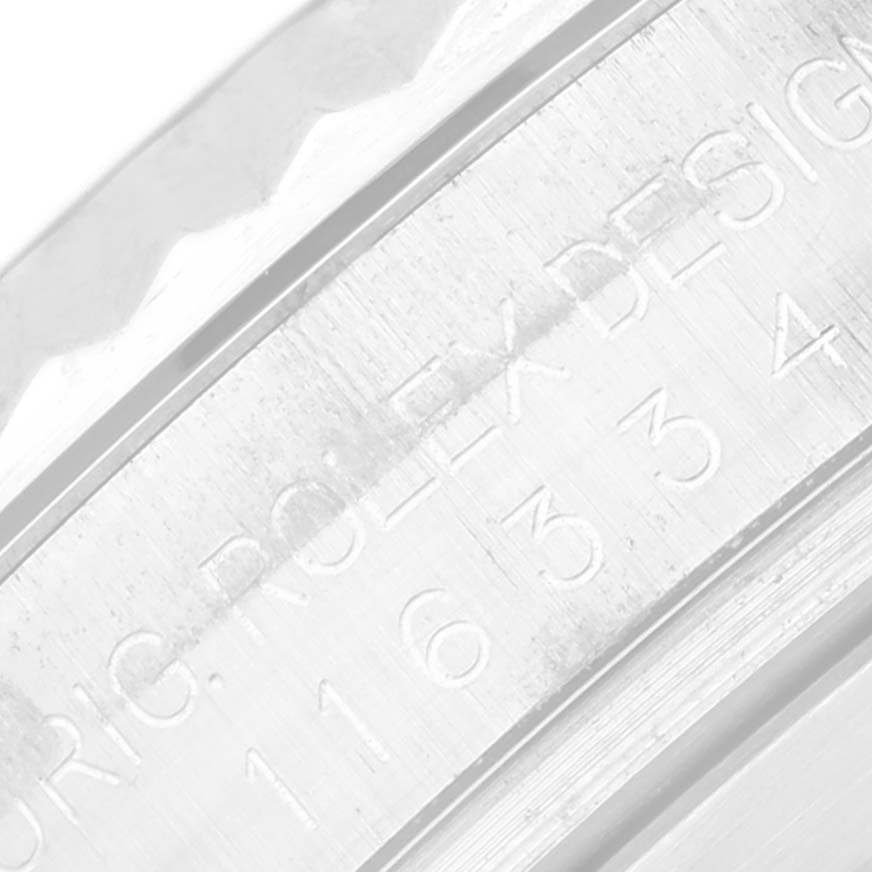 The image shows a close-up view of the engraved branding on the inner bezel of a Rolex Datejust 41 116334 Men
s Stainless Steel Blue Dial 116334 Men
s Stainless Steel Blue Dial watch.