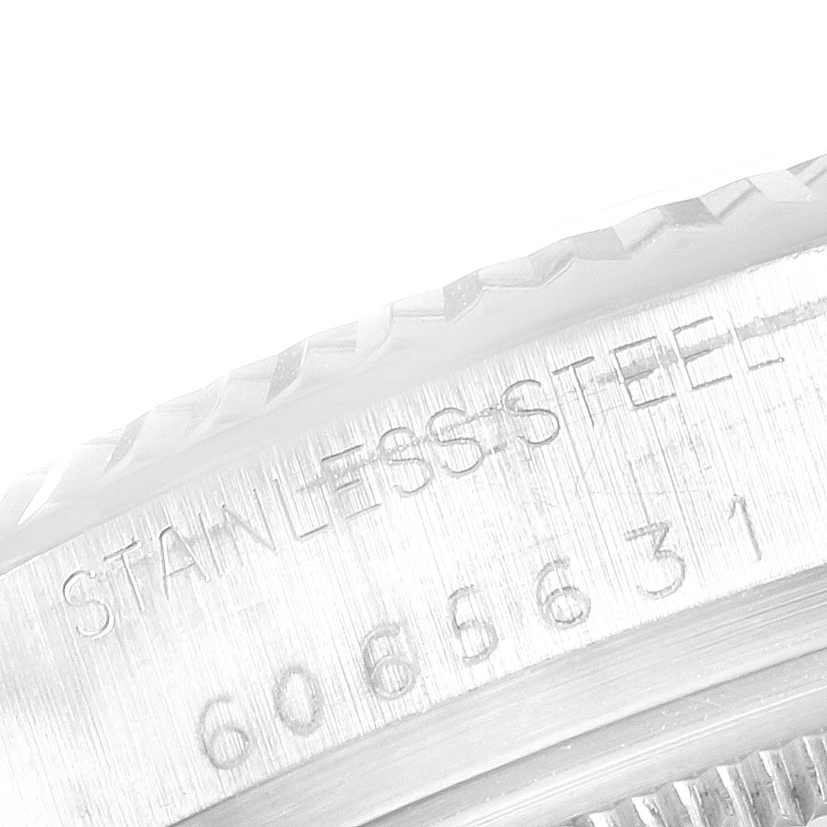 The image shows a close-up of the stainless steel case back edge of the Rolex Vintage Collection 16014 Men
s Stainless Steel Silver Dial 16014 Men
s Stainless Steel Silver Dial model, displaying part of its serial number.