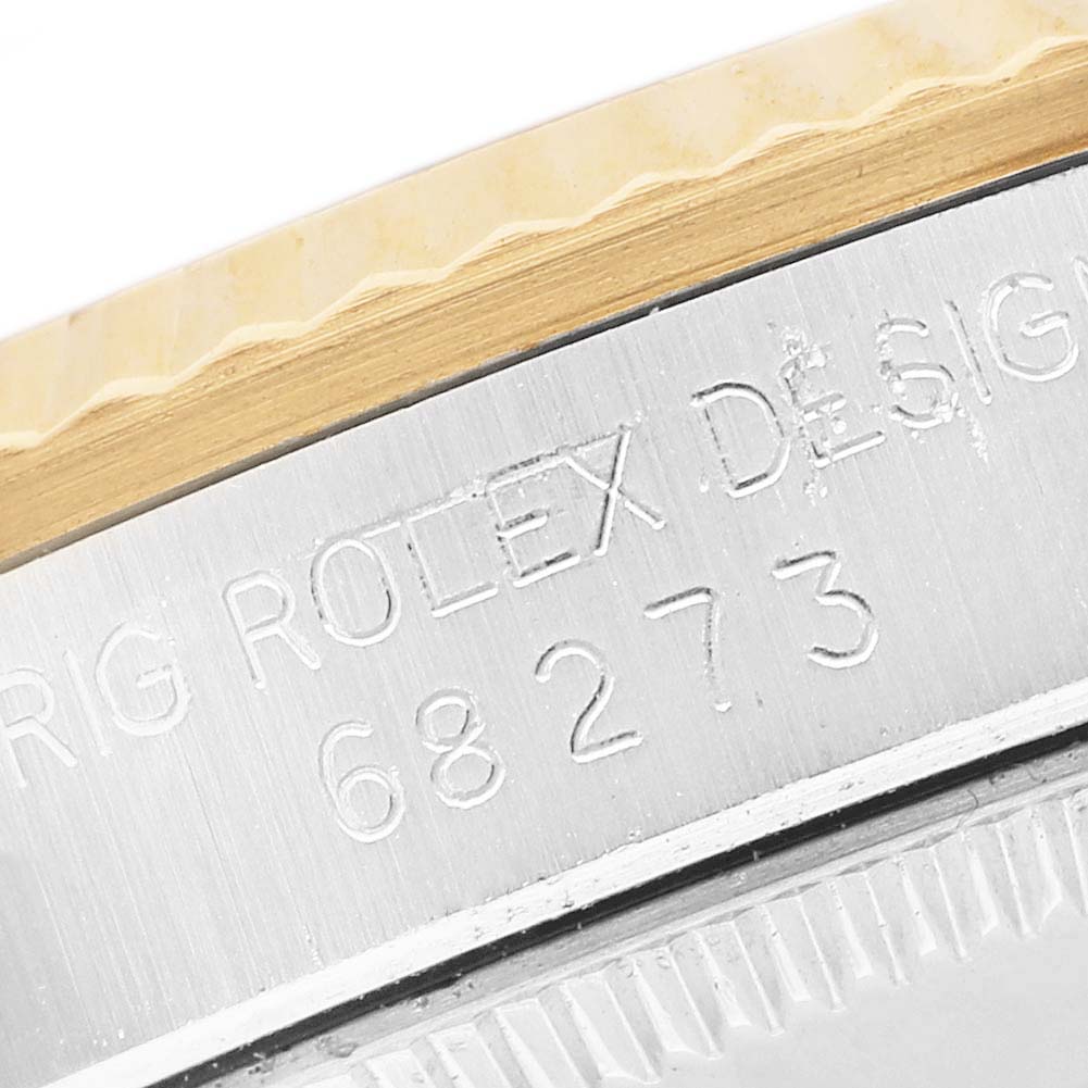 The image shows a close-up angle of the side of a Rolex Mid-Size 68273 Women's Steel and Gold (two tone) Champagne Dial watch, focusing on the engravings and bezel detailing.