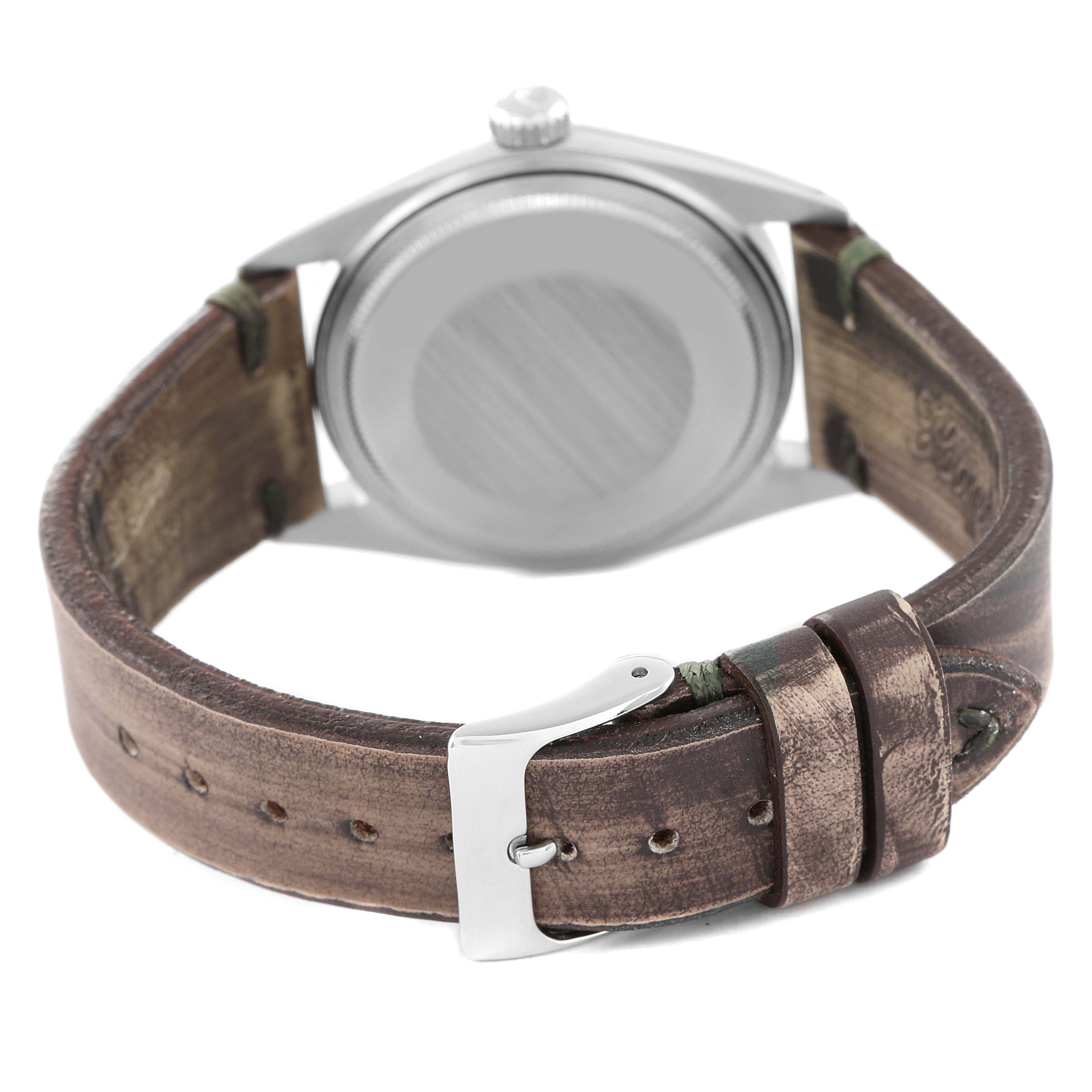 The image shows the back of the Rolex Vintage Collection 1603 Men's Stainless Steel Silver Dial 1603 Men's Stainless Steel Silver Dial watch, focusing on the leather strap and case back.