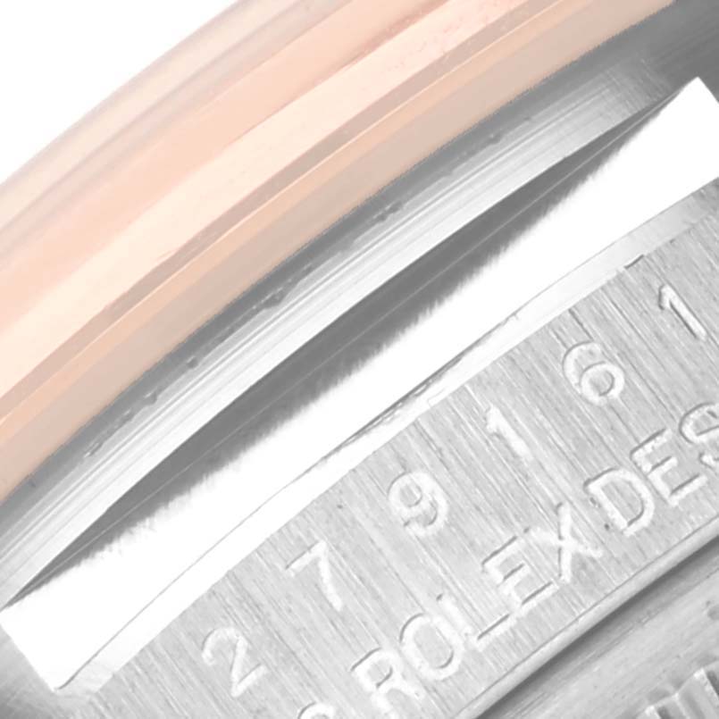 This close-up image shows the edge of the case and part of the serial number engraving on a Rolex Datejust 279161 Women's Steel and Gold (two tone) Mother of Pearl Dial 279161 Women's Steel and Gold (two tone) Mother of Pearl Dial model watch.