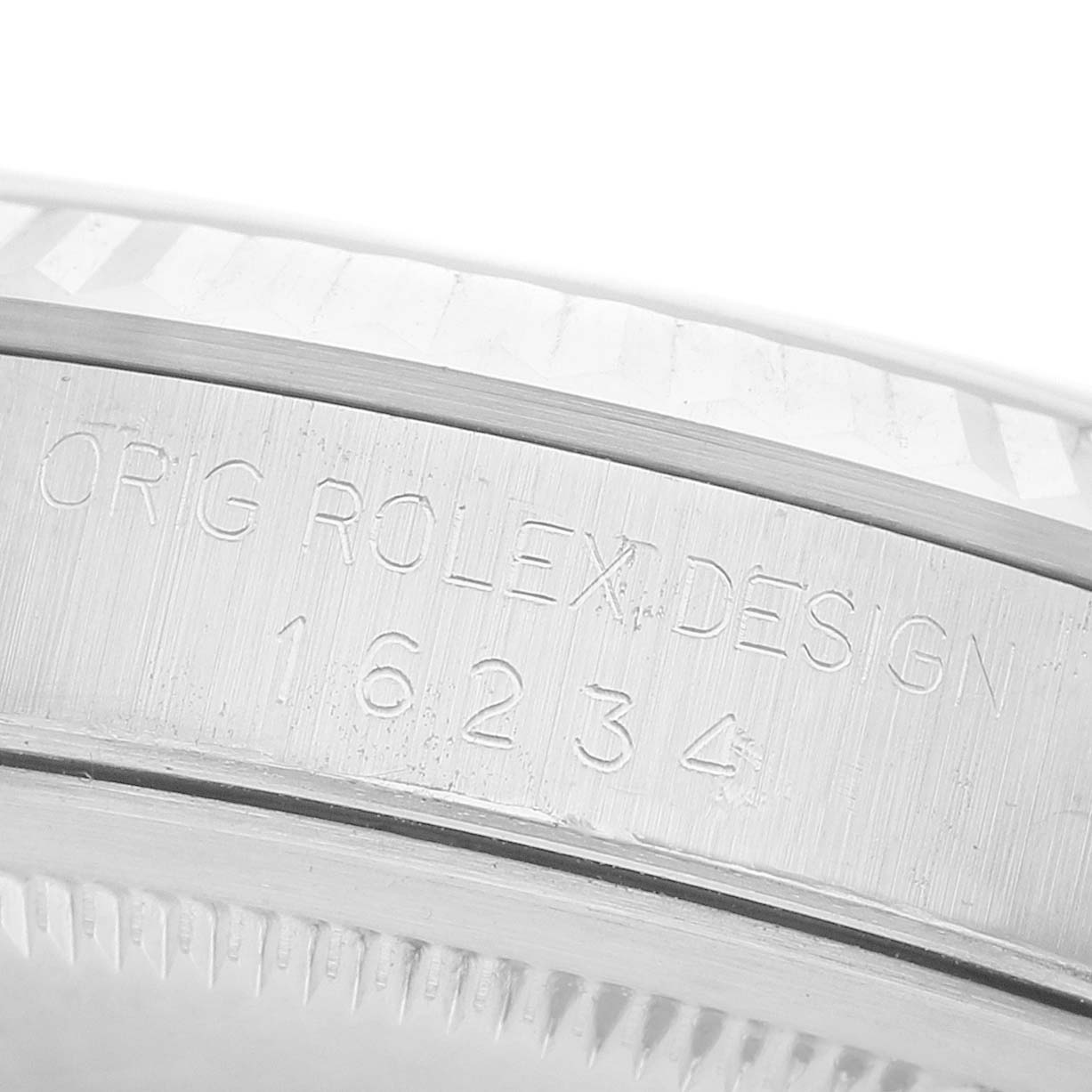 The image shows a close-up of the side of a Rolex Datejust 16234 Men's Stainless Steel Silver Dial watch, highlighting engraved text on the casing.