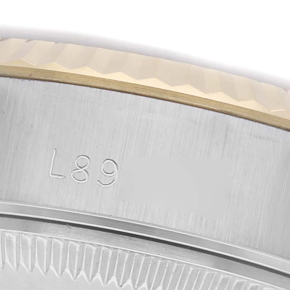 The image shows a close-up of the bezel edge and engraved serial number of a Rolex Datejust 69173 Women's Steel and Gold (two tone) Champagne Dial 69173 Women's Steel and Gold (two tone) Champagne Dial watch.