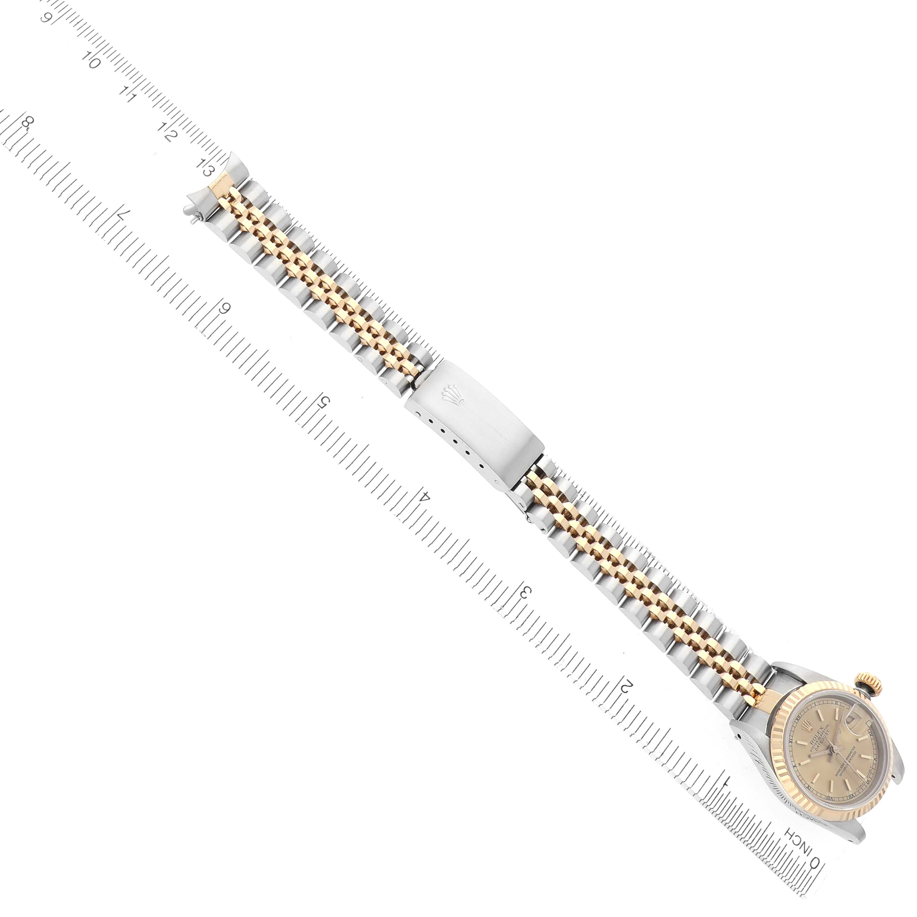 The Rolex Datejust 69173 Women's Steel and Gold (two tone) Champagne Dial 69173 Women's Steel and Gold (two tone) Champagne Dial watch is shown from a top view, highlighting its gold and silver bracelet, clasp, and partially visible dial.