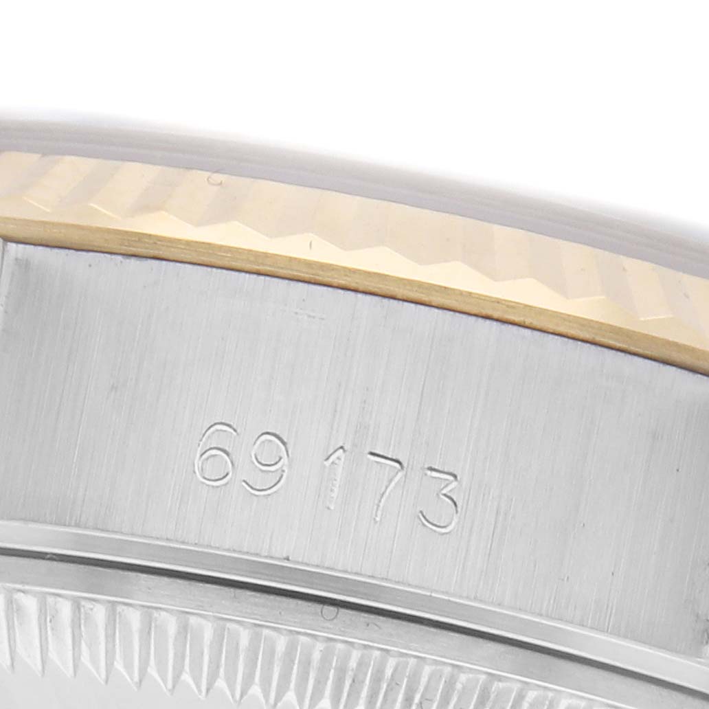 The image shows a close-up of the bezel and serial number on a Rolex Datejust 69173 Women's Steel and Gold (two tone) Champagne Dial 69173 Women's Steel and Gold (two tone) Champagne Dial watch, highlighting the engraved detailing.