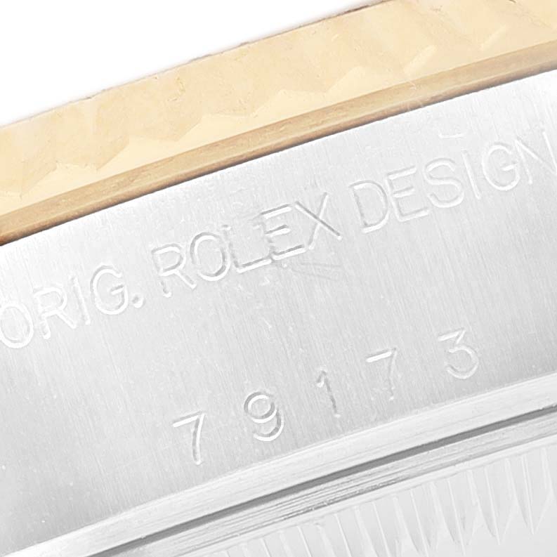 The image shows a close-up of the case side with engravings on a Rolex Datejust 79173 Women's Steel and Gold (two tone) Champagne Dial watch.