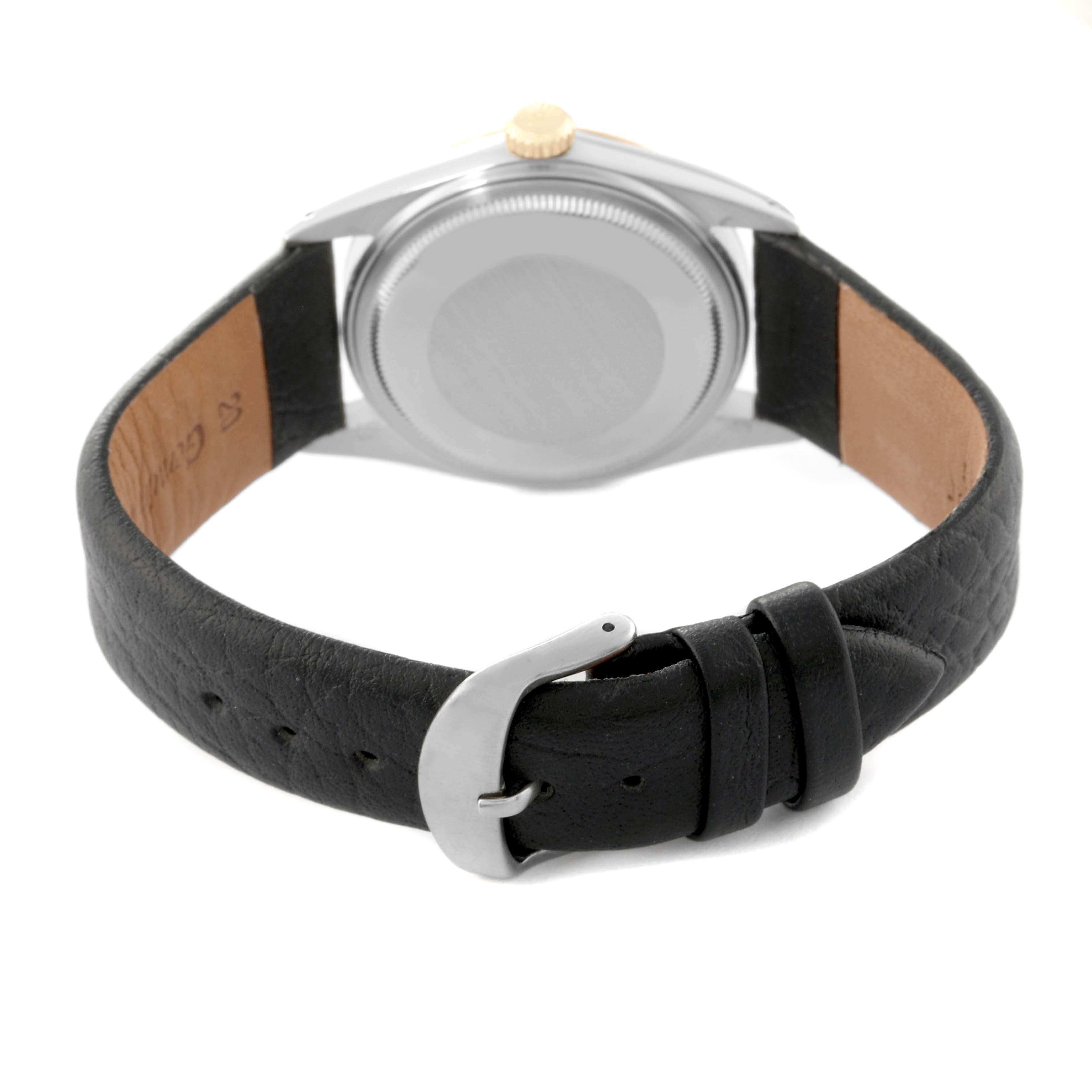 The image shows the back view of a Rolex Vintage Collection 16013 Men's Steel and Gold (two tone) Champagne Dial 16013 Men's Steel and Gold (two tone) Champagne Dial watch, highlighting the case back and black leather strap with a buckle.