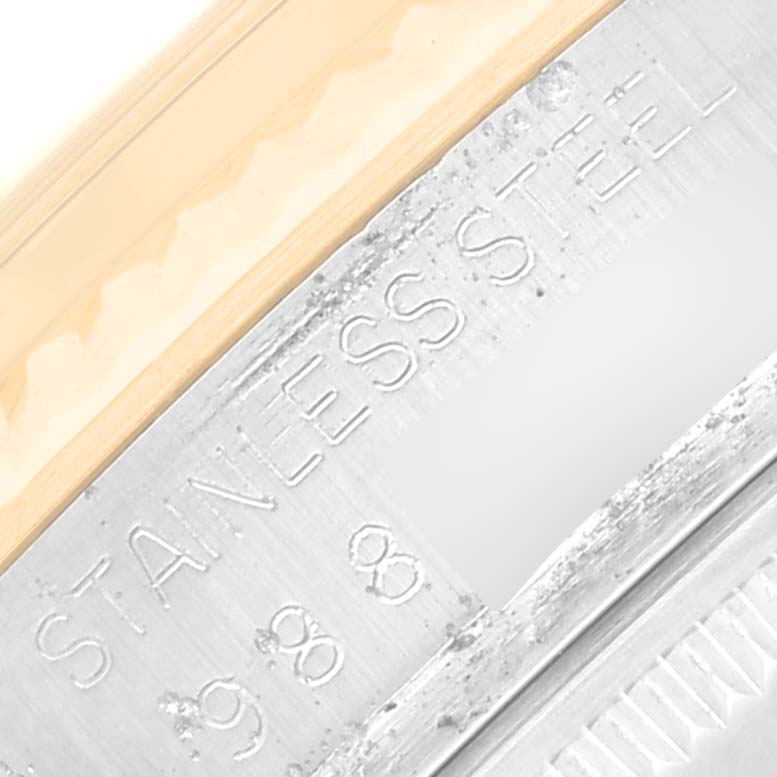 This close-up image shows the side engraving of a vintage Rolex watch, indicating "Stainless Steel."