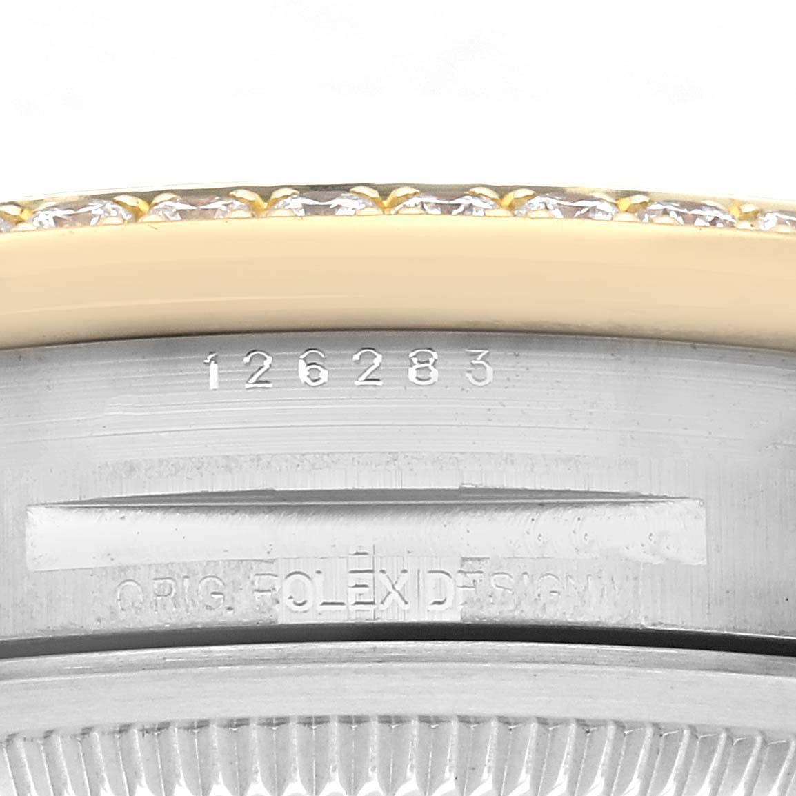 The image shows a close-up of the side of a Rolex Datejust 126283 Men's Steel and Gold (two tone) Champagne Dial 126283 Men's Steel and Gold (two tone) Champagne Dial watch, highlighting the serial number and part of the bezel.