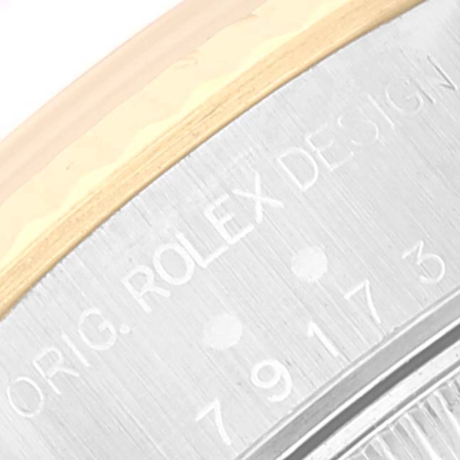 This close-up image shows the side of the case of a Rolex Datejust 79173 Women's Steel and Gold (two tone) Champagne Dial 79173 Women's Steel and Gold (two tone) Champagne Dial watch, focusing on the engraved design details.