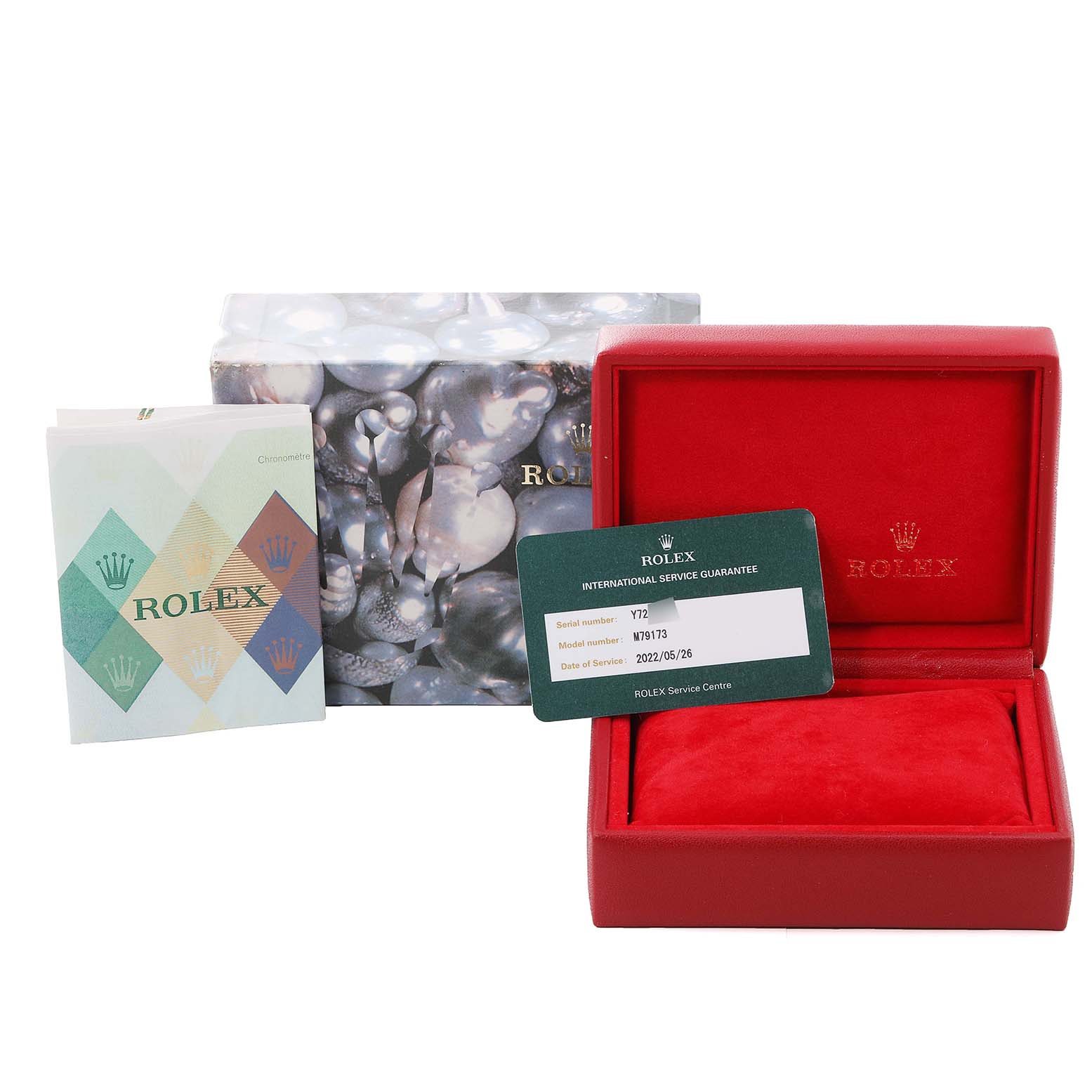 The image shows the packaging, service booklet, and international service guarantee card for a Rolex Datejust 79173 Women's Steel and Gold (two tone) Champagne Dial 79173 Women's Steel and Gold (two tone) Champagne Dial model watch.