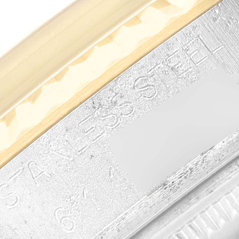 This image shows a close-up of the edge of a Rolex Vintage Collection 16013 Men's Steel and Gold (two tone) Champagne Dial 16013 Men's Steel and Gold (two tone) Champagne Dial watch, focusing on the stainless steel part near the watch's bezel.