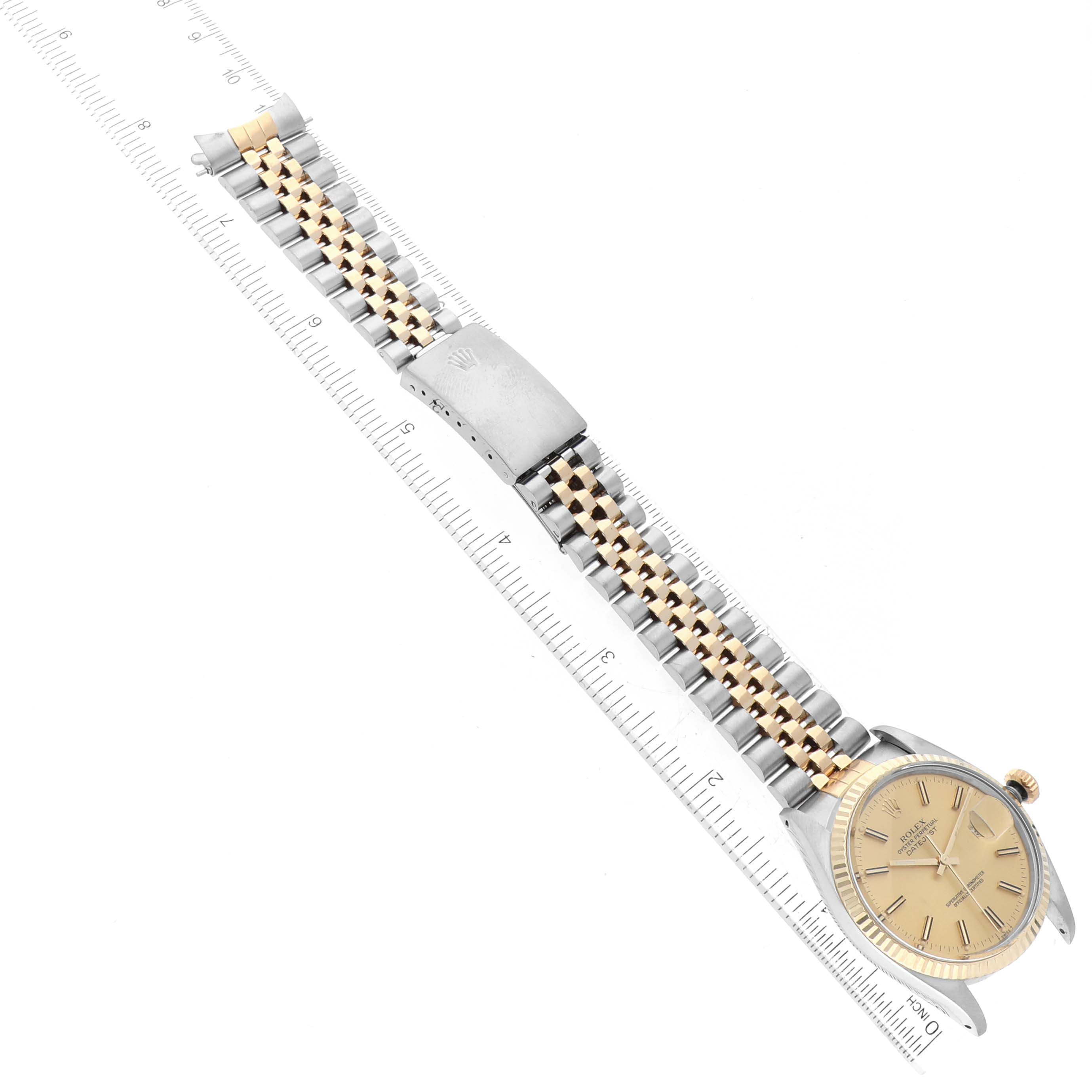 This Rolex Vintage Collection 16013 Men's Steel and Gold (two tone) Champagne Dial 16013 Men's Steel and Gold (two tone) Champagne Dial model is shown from a top-down angle, displaying the full watch and bracelet with a ruler for scale.