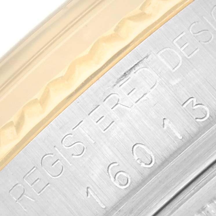 A close-up angle of the side casing of a Rolex Vintage Collection 16013 Men's Steel and Gold (two tone) Champagne Dial 16013 Men's Steel and Gold (two tone) Champagne Dial model, showing engraved details and part of the bezel.