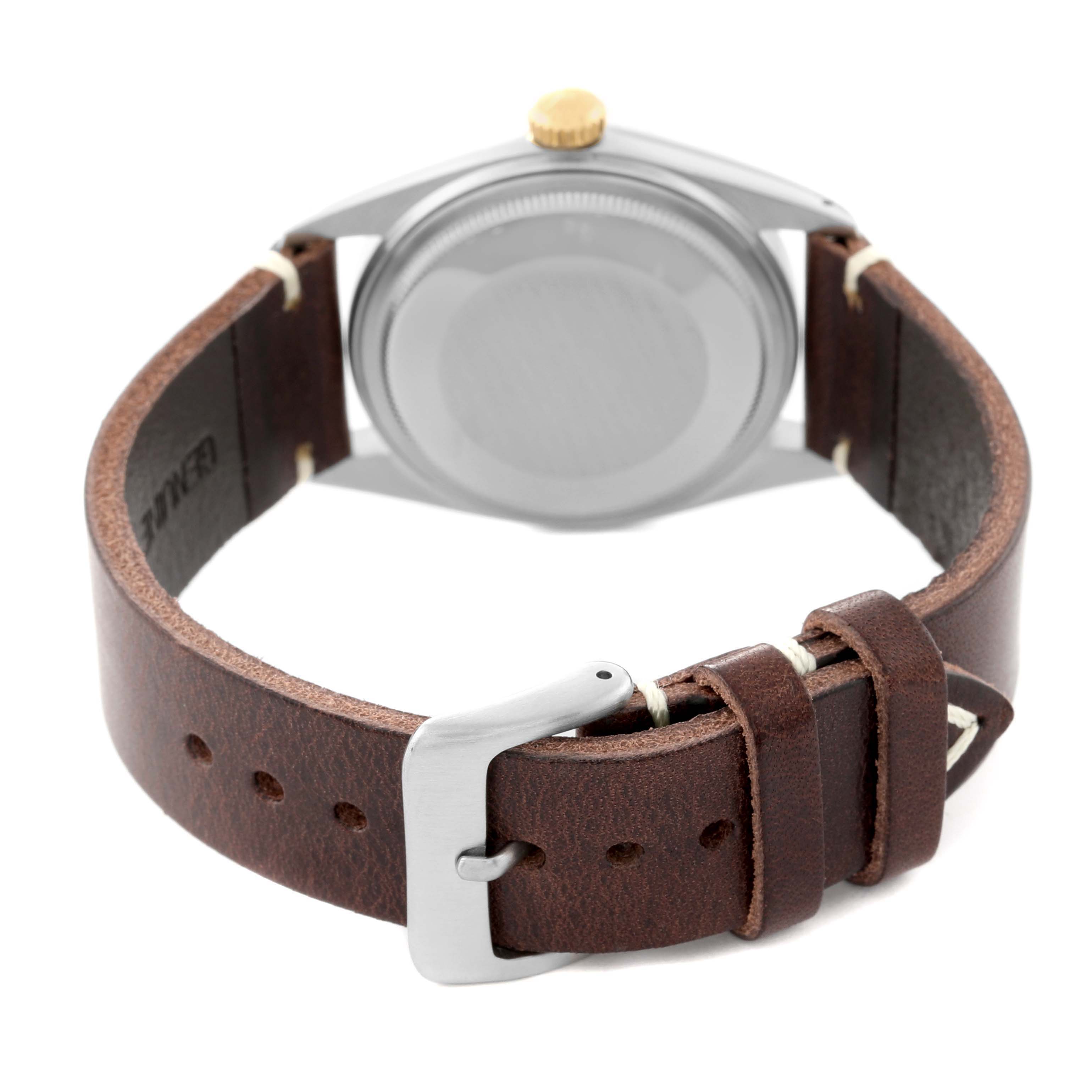 The image shows the back of the Rolex Vintage Collection 16013 Men's Steel and Gold (two tone) Champagne Dial 16013 Men's Steel and Gold (two tone) Champagne Dial model watch and its brown leather strap with the buckle visible.