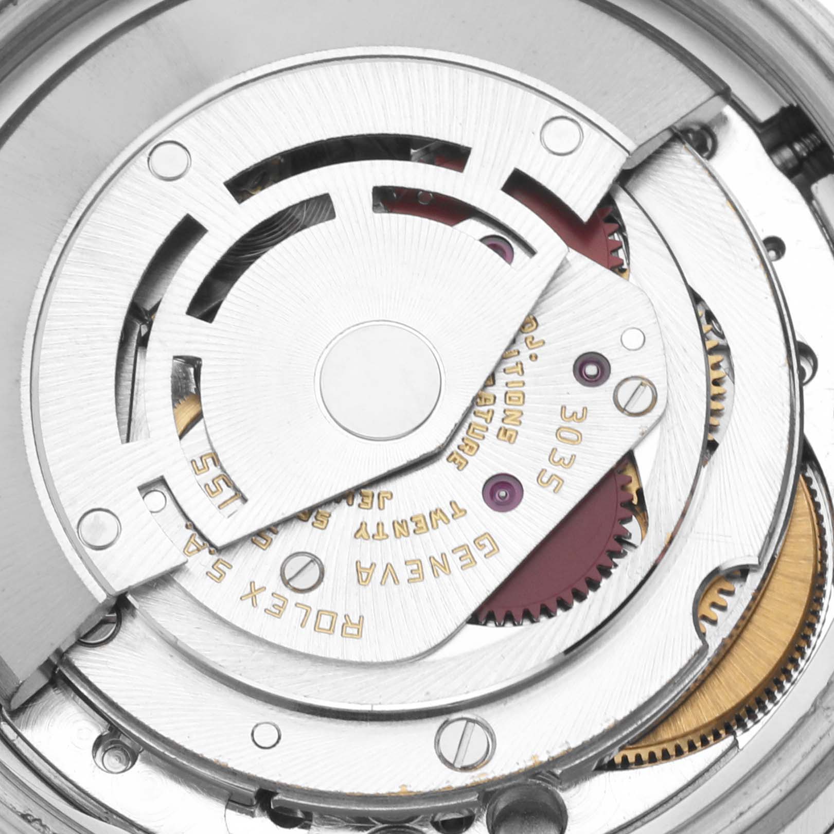 This image shows an internal view of the movement mechanism of a Vintage Collection Rolex watch, highlighting its intricate parts and engravings.