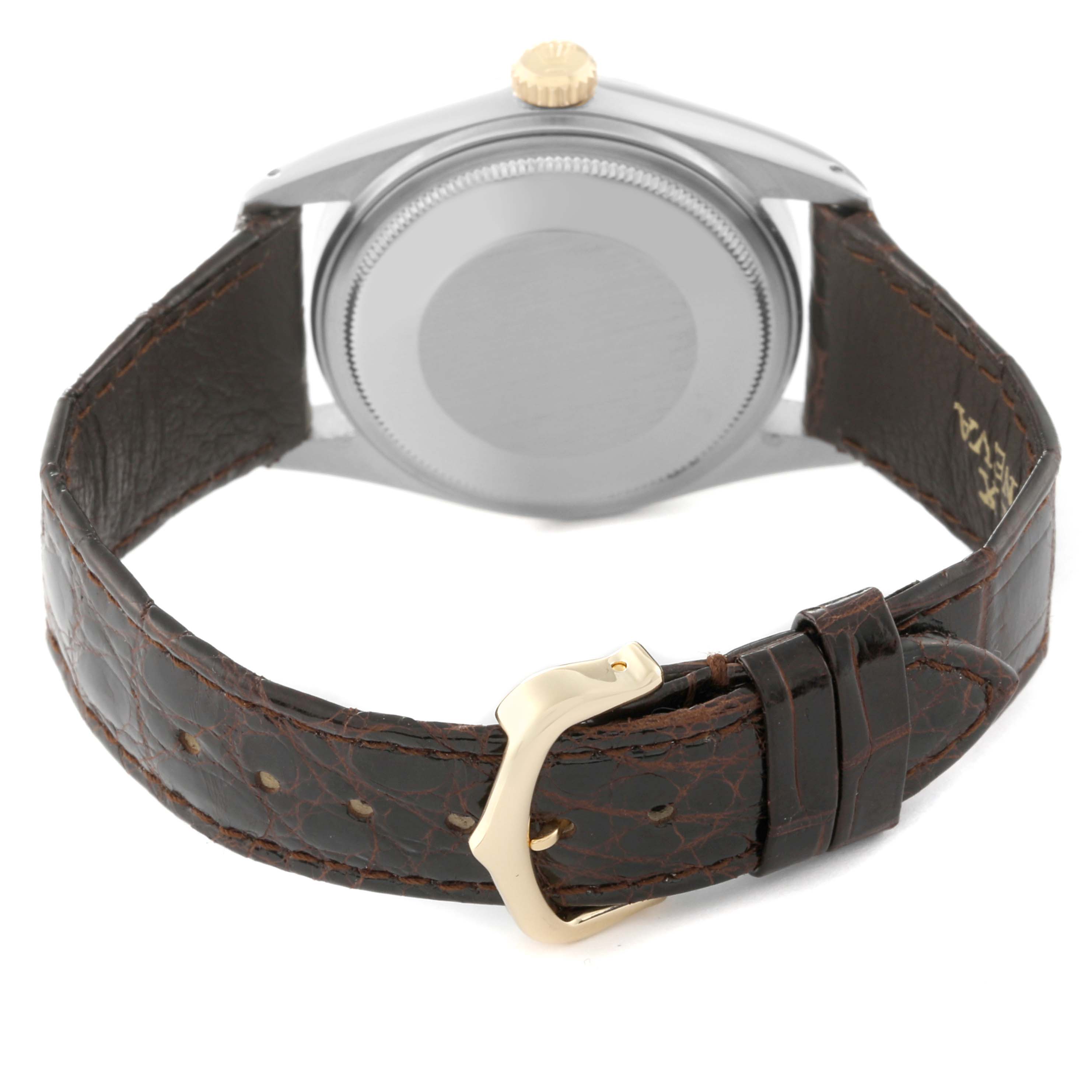 This image shows the back of a Rolex Vintage Collection 16013 Men's Steel and Gold (two tone) White Dial 16013 Men's Steel and Gold (two tone) White Dial watch with a brown leather strap and a gold buckle.