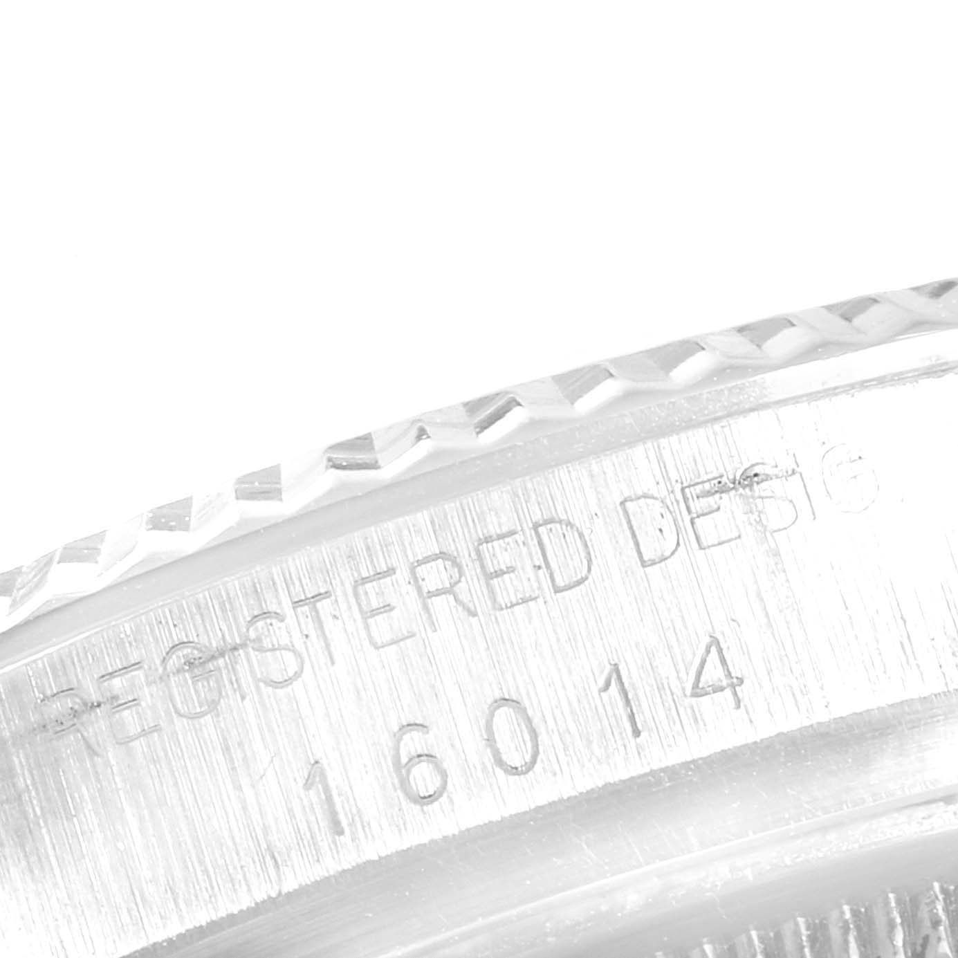 This image shows a close-up of the edge of a Rolex Vintage Collection 16014 Men
s Stainless Steel Black Dial 16014 Men
s Stainless Steel Black Dial watch, focusing on the engraved serial number and design details.