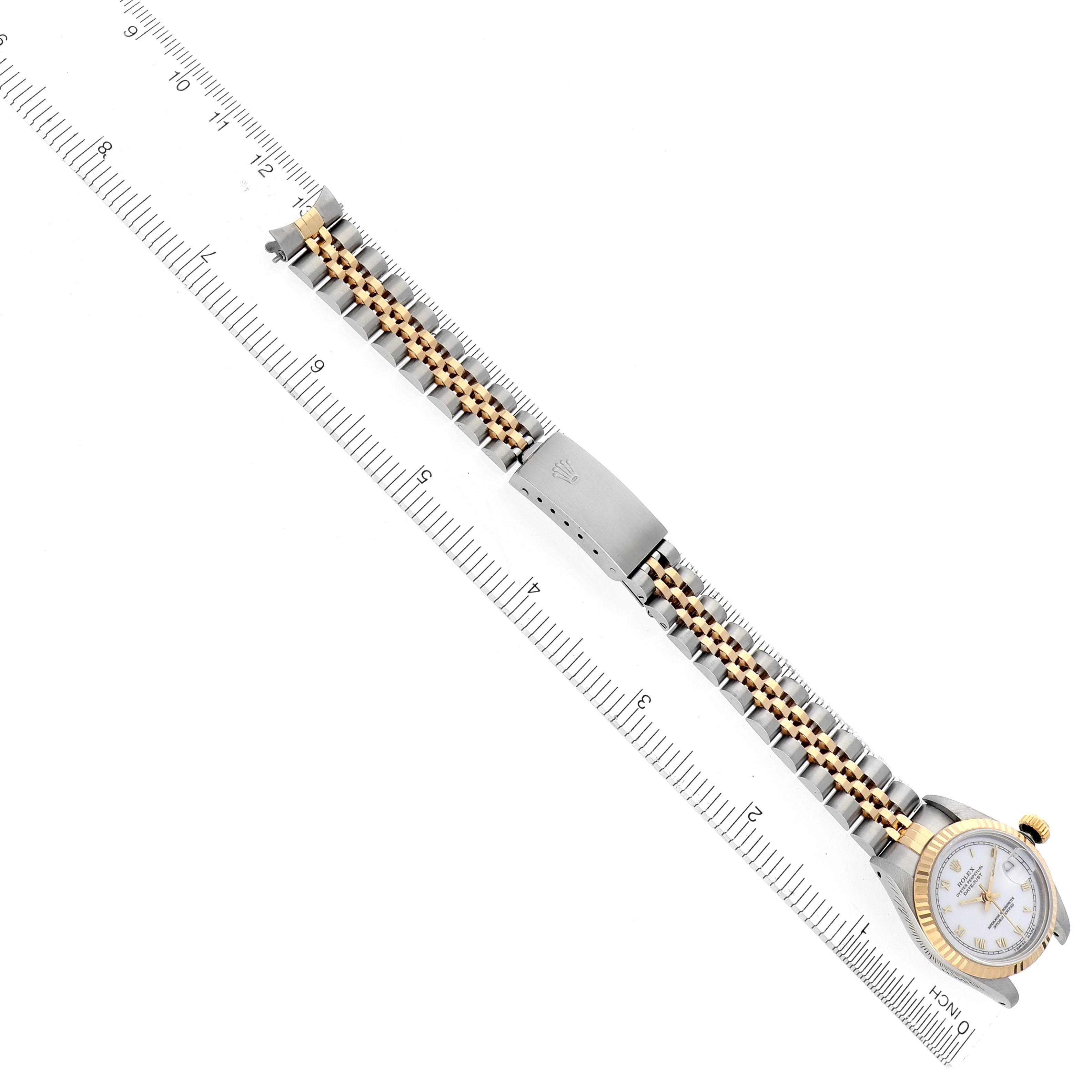 The Rolex Datejust 69173 Women's Steel and Gold (two tone) White Dial 69173 Women's Steel and Gold (two tone) White Dial watch is shown from the top, displaying the dial, clasp, and full bracelet alongside a ruler.