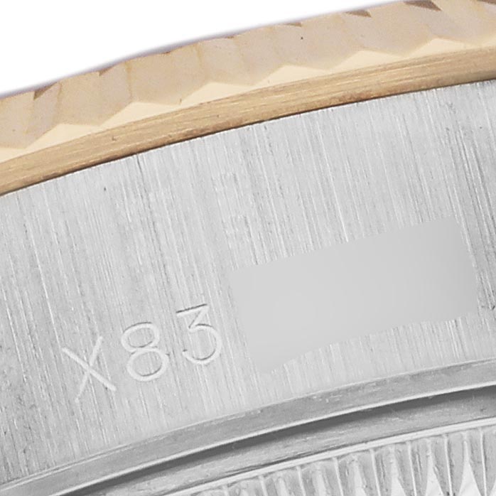The image shows a close-up of the Rolex Datejust 69173 Women's Steel and Gold (two tone) White Dial 69173 Women's Steel and Gold (two tone) White Dial's fluted bezel and part of the case side with engraved markings.