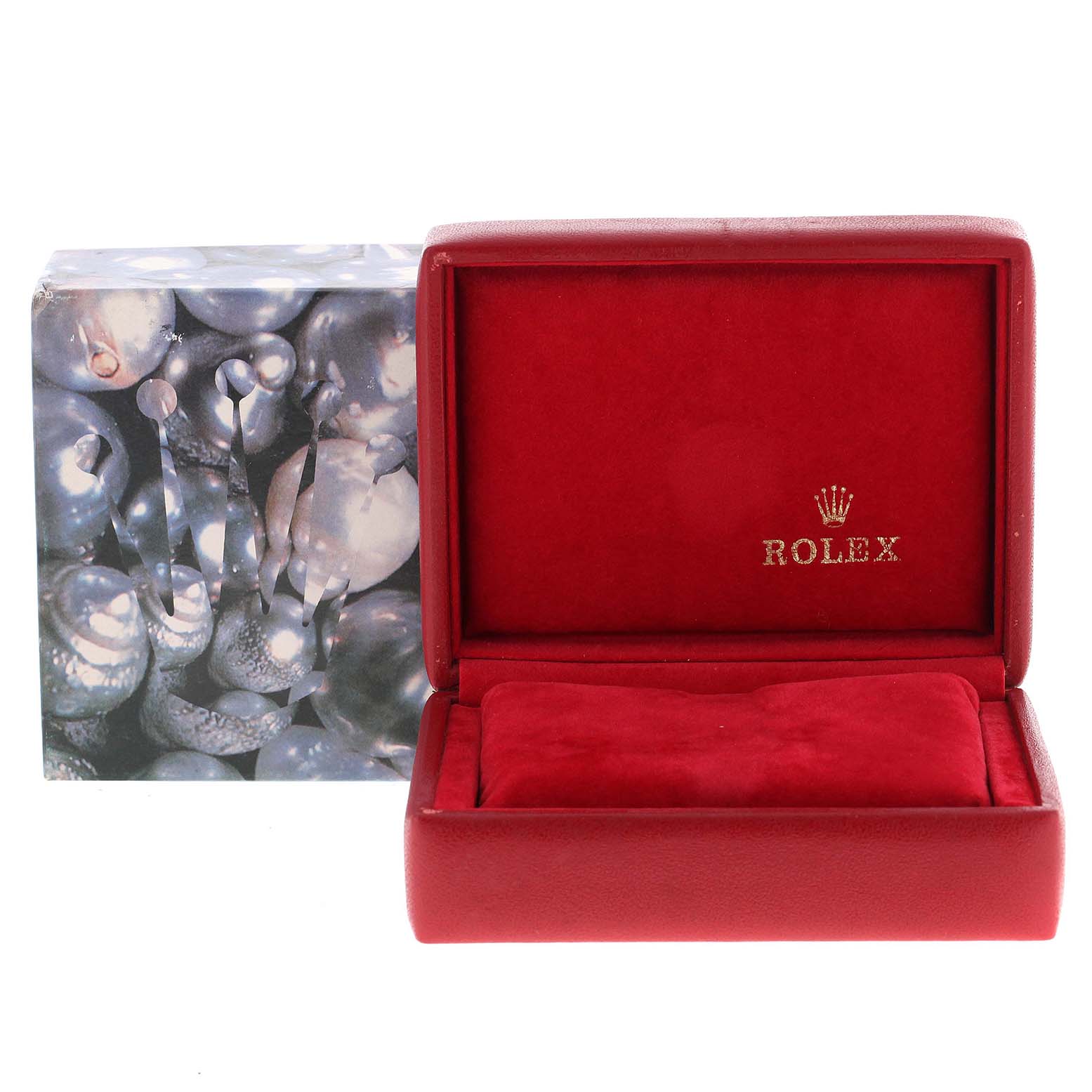 The image shows an empty Rolex Datejust 79173 Women's Steel and Gold (two tone) Purple Dial 79173 Women's Steel and Gold (two tone) Purple Dial watch box open at a front angle, with a decorative outer box in the background.