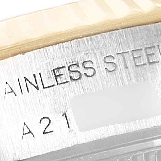 This is a close-up view of the case side of a Rolex Datejust 79173 Women's Steel and Gold (two tone) Purple Dial 79173 Women's Steel and Gold (two tone) Purple Dial watch, showing part of the serial number and "STAINLESS STEEL" engraving.