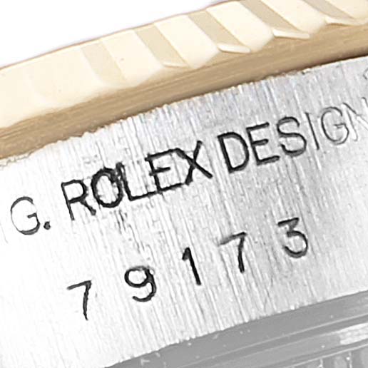 This image shows a close-up of the model number and part of the bezel of a Rolex Datejust 79173 Women's Steel and Gold (two tone) Purple Dial 79173 Women's Steel and Gold (two tone) Purple Dial watch.