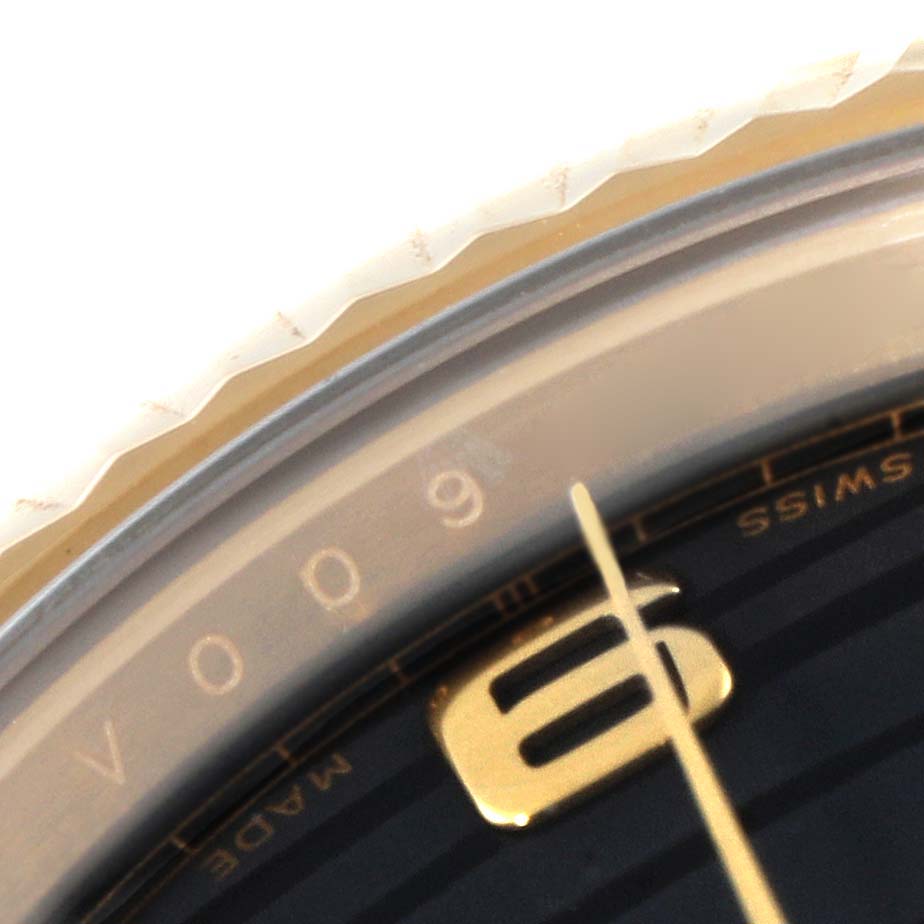 The image shows a close-up of the dial and bezel of a Rolex President 218238 Men's Yellow Gold Black Dial 218238 Men's Yellow Gold Black Dial model watch, highlighting the number six and part of the minute hand.