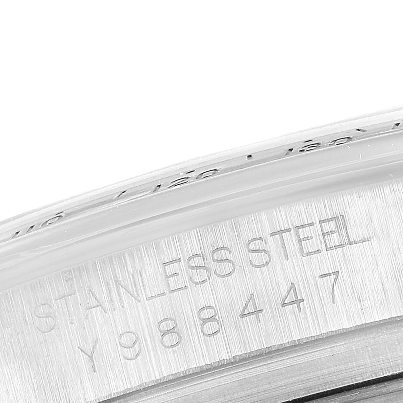 This close-up image shows the stainless steel case and serial number engraving of a Rolex Daytona 116520 Men's Stainless Steel Black Dial 116520 Men's Stainless Steel Black Dial watch.