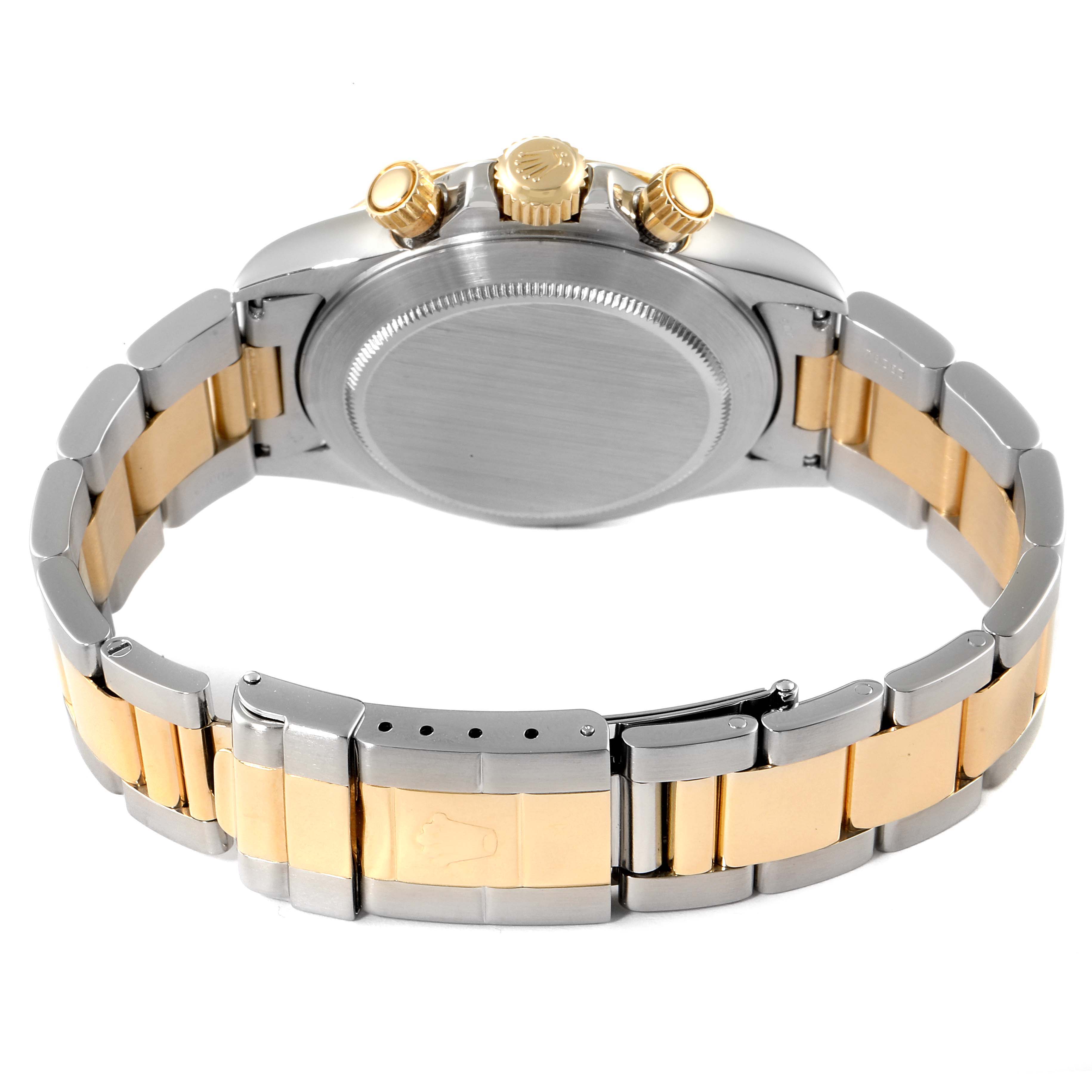 The image shows the backside of a Rolex Daytona 16523 Men's Steel and Gold (two tone) Black Dial 16523 Men's Steel and Gold (two tone) Black Dial, highlighting the case back, crown, pushers, and the two-tone bracelet.