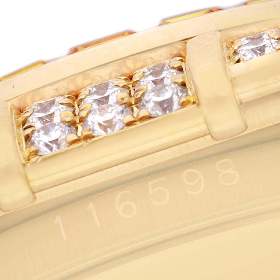 The image shows a close-up of the diamond-studded bezel and partial band of a Rolex Daytona 116598 Men's Yellow Gold Orange Dial 116598 Men's Yellow Gold Orange Dial watch.