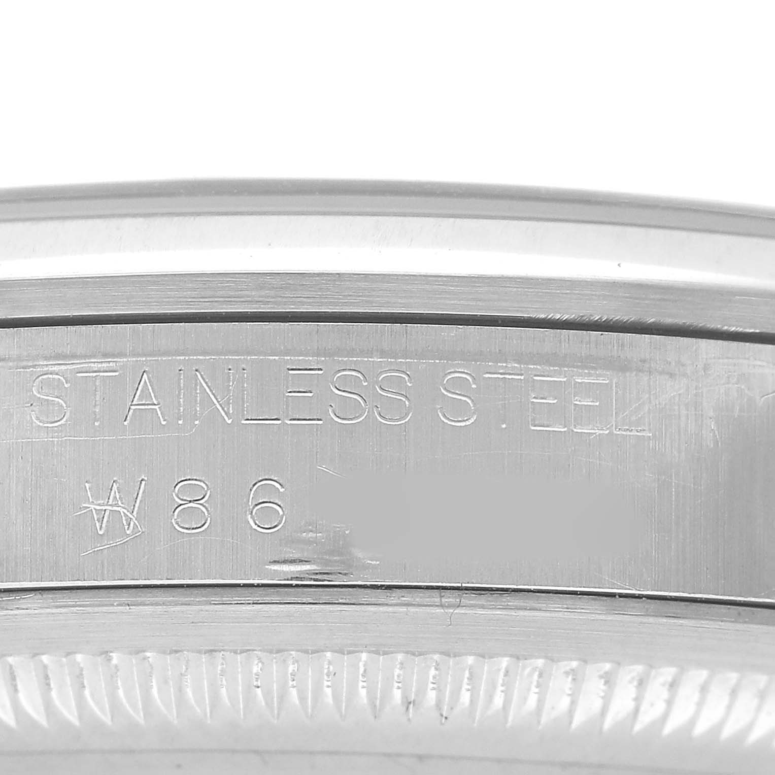 The image shows a close-up of the stainless steel case back engraving on a Rolex Explorer 14270 Men's Stainless Steel Black Dial watch.