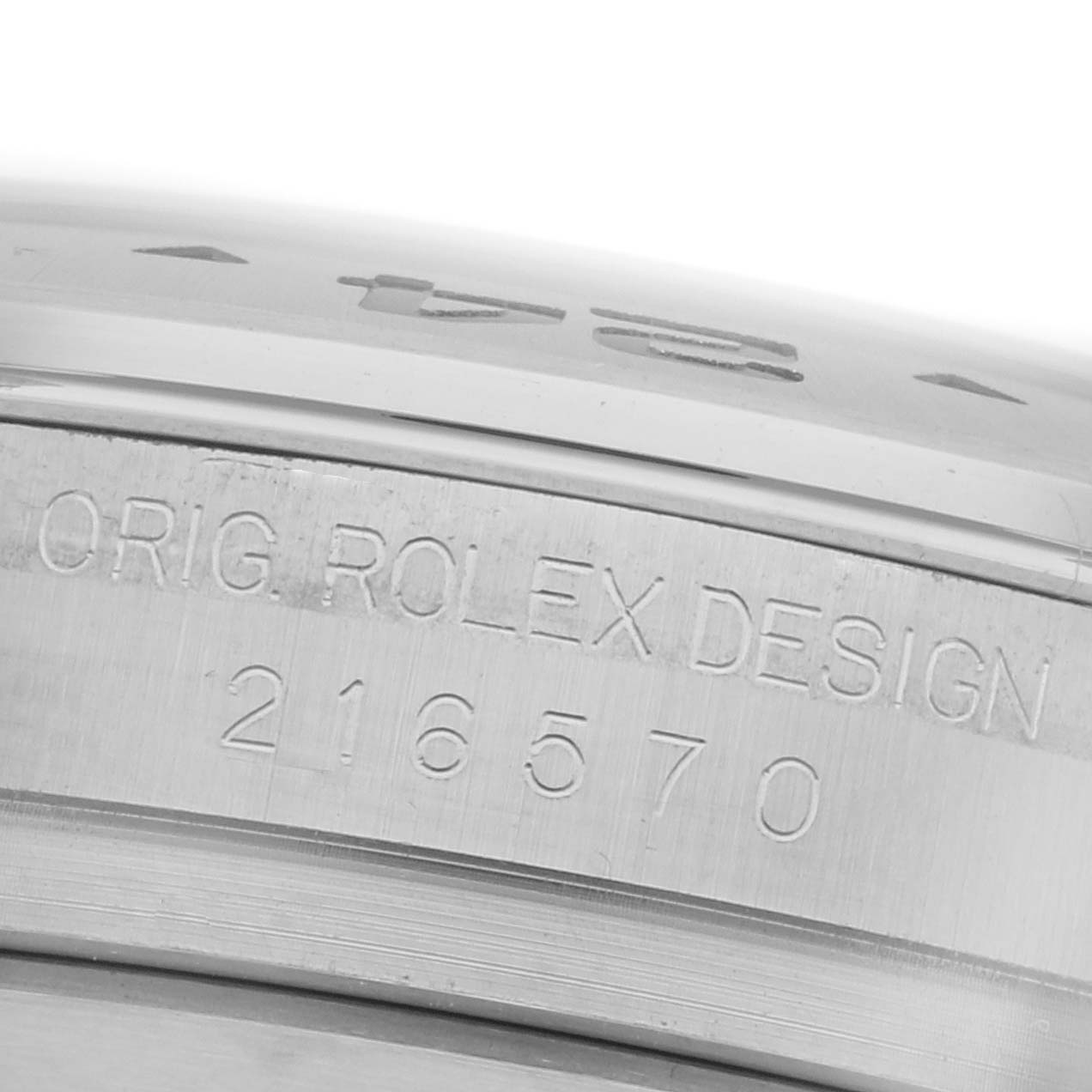 The image shows a close-up of the serial number and "ORIG. ROLEX DESIGN" engraving on the side of a Rolex Explorer 216570 Men's Stainless Steel Black Dial 216570 Men's Stainless Steel Black Dial watch case.