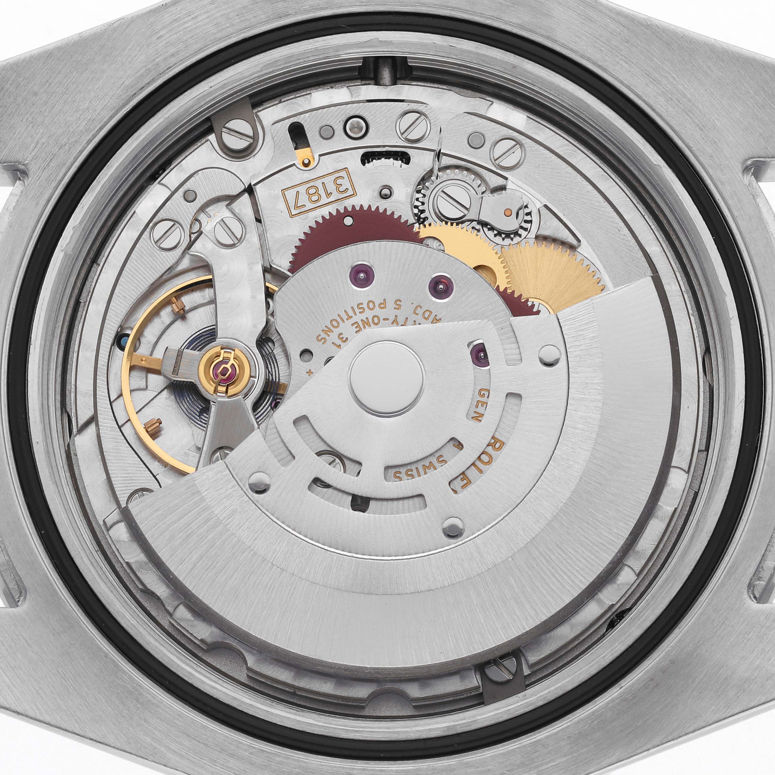 The image shows a close-up of the movement inside a Rolex Explorer 216570 Men's Stainless Steel Black Dial 216570 Men's Stainless Steel Black Dial watch, highlighting gears and mechanical components.