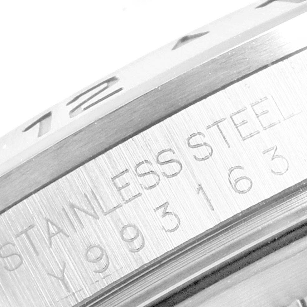 The image shows a close-up of the bezel and case of a Rolex Explorer 16570 Men
s Stainless Steel Black Dial 16570 Men
s Stainless Steel Black Dial, highlighting the stainless steel engraving and part of the serial number.