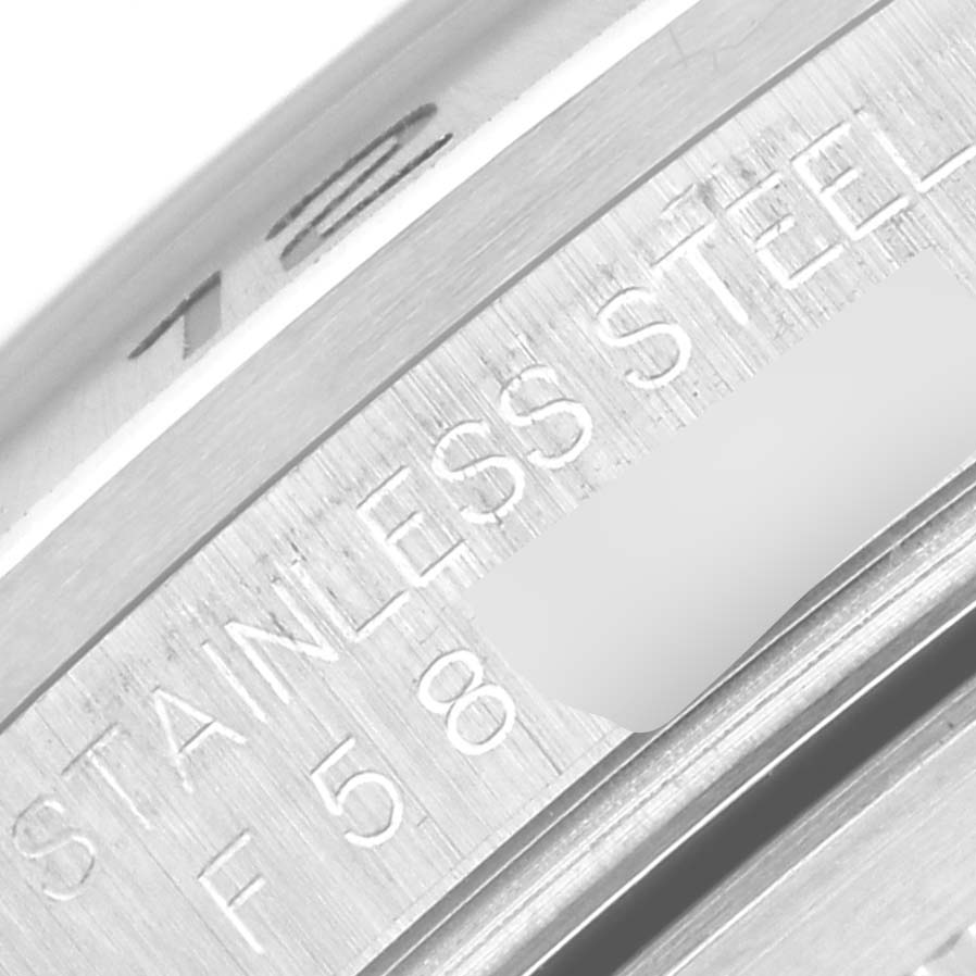 The image shows a close-up of the stainless steel engraving and part of the bezel on a Rolex Explorer 16570 Men
s Stainless Steel Black Dial 16570 Men
s Stainless Steel Black Dial watch.