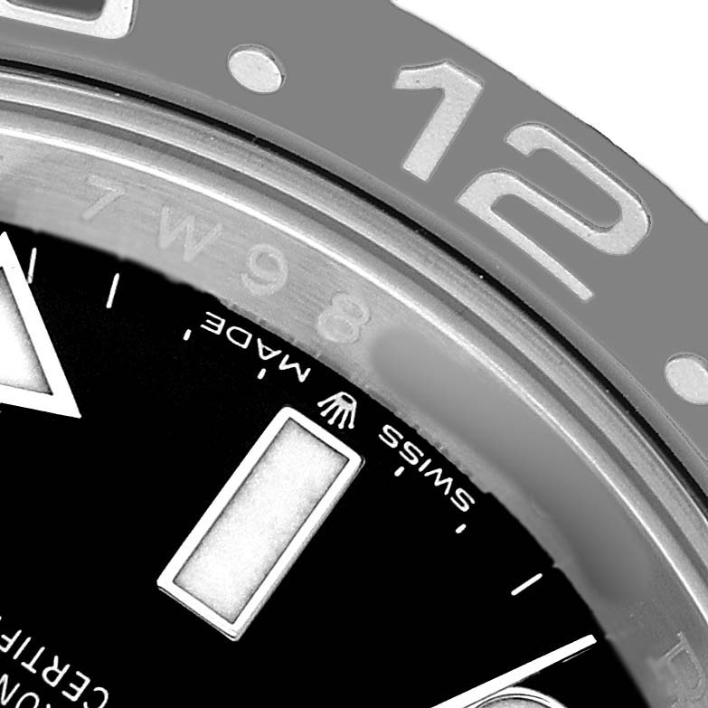 The image shows a close-up of the bezel and dial on a Rolex GMT-Master 126710 Men's Stainless Steel Black Dial, highlighting hour markers and part of the 12 o'clock position.