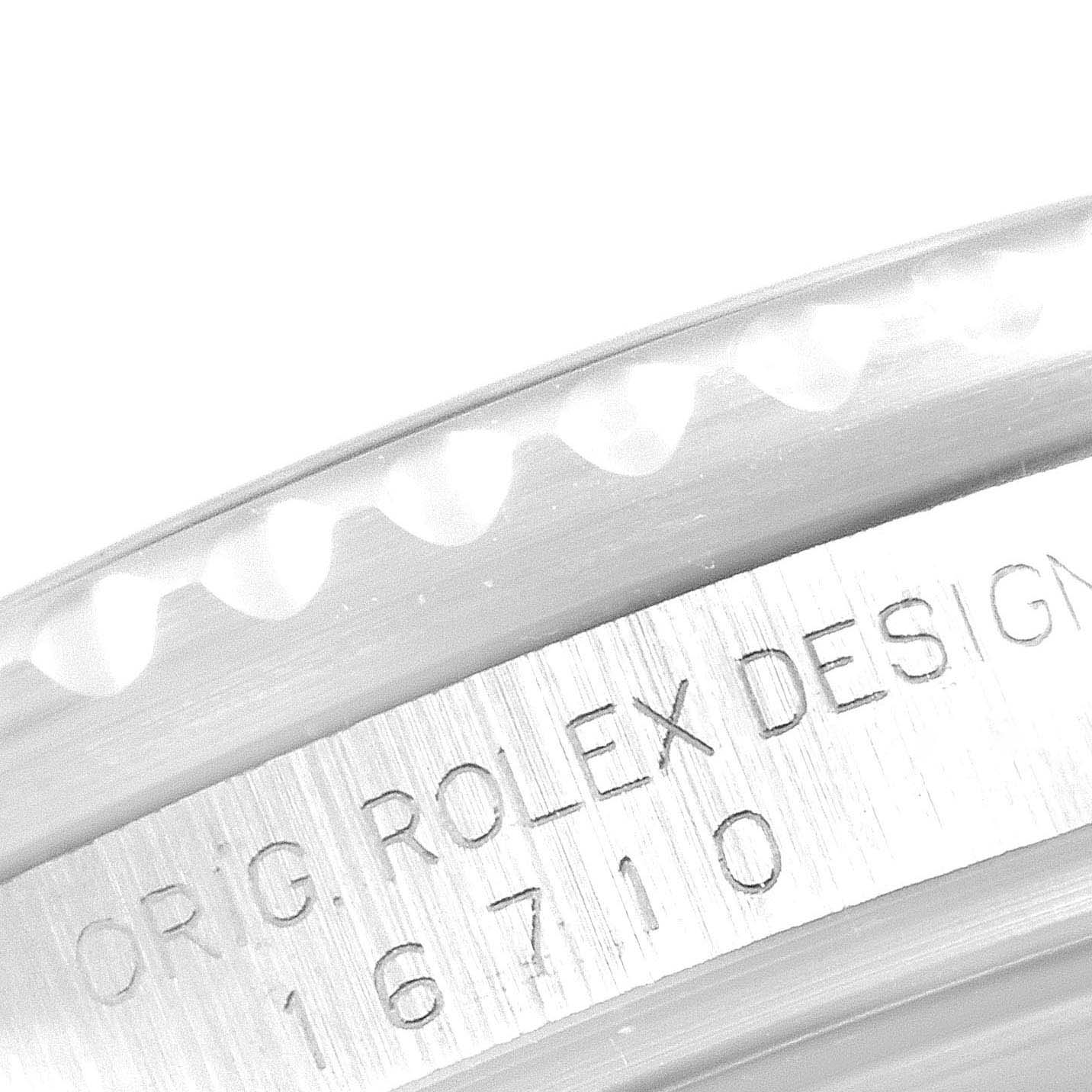 The image shows a close-up angle of the GMT-Master Rolex watch bezel and engraved case back.