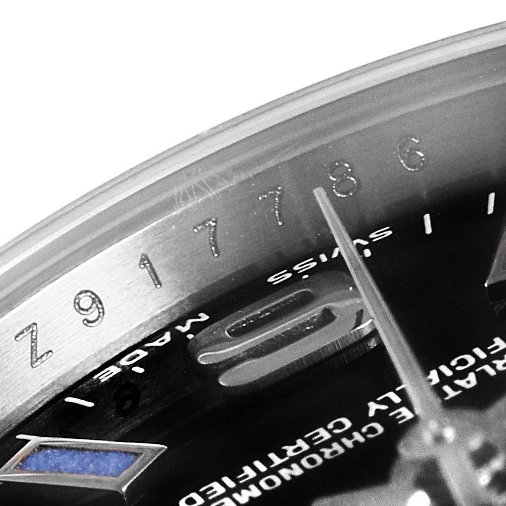 The image shows a close-up angle of the dial and the edge of the Oyster Perpetual Rolex watch.