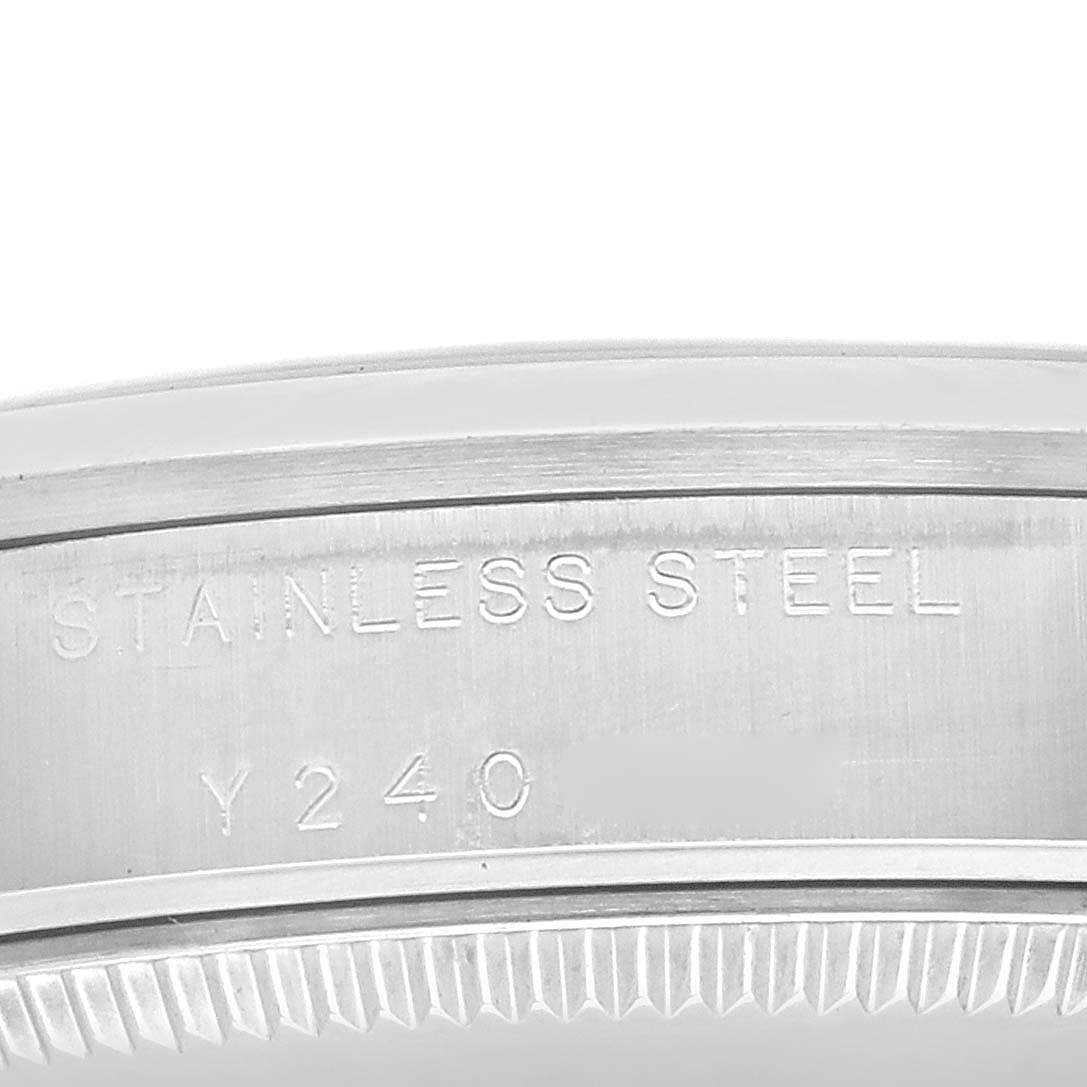 This close-up image shows the case back engraving on a Rolex Mid-Size 77080 Women
s Stainless Steel White Dial 77080 Women
s Stainless Steel White Dial model, indicating "STAINLESS STEEL" and a partial serial number.