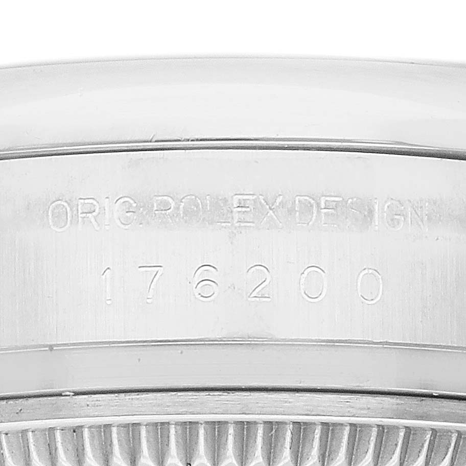This image shows the side engraving of the Rolex Oyster Perpetual 176200 Women's Stainless Steel Silver Dial 176200 Women's Stainless Steel Silver Dial watch, displaying the model number and "ORIG ROLEX DESIGN."