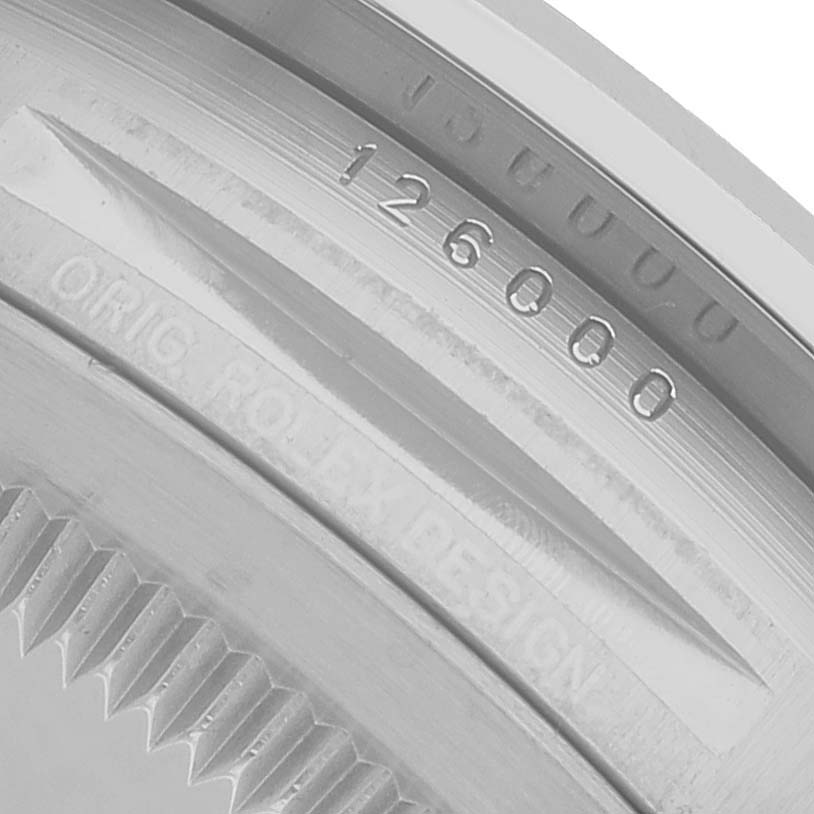 The image shows a close-up of the model number engraving on the case of a Rolex Oyster Perpetual 126000 Men's Stainless Steel Black Dial watch.